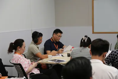Delegation members discussing around a table during the workshop