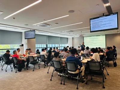 Workshop classroom at Alibaba with participants seated in groups